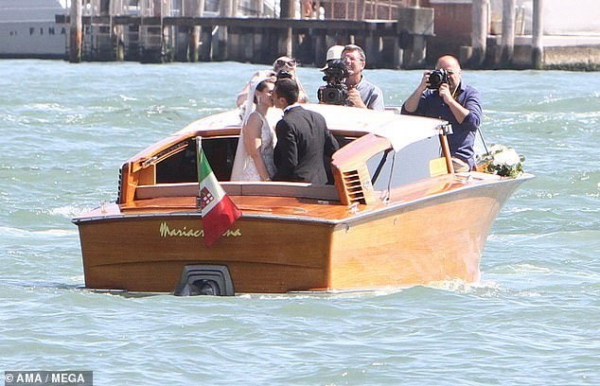 Henrikh Mkhitaryan kisses his beautiful bride Betty Vardanyan during romantic boat ride in Venice after getting married